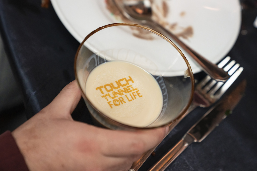 Peanut butter whiskey martini with edible Touch Tunnel logo

