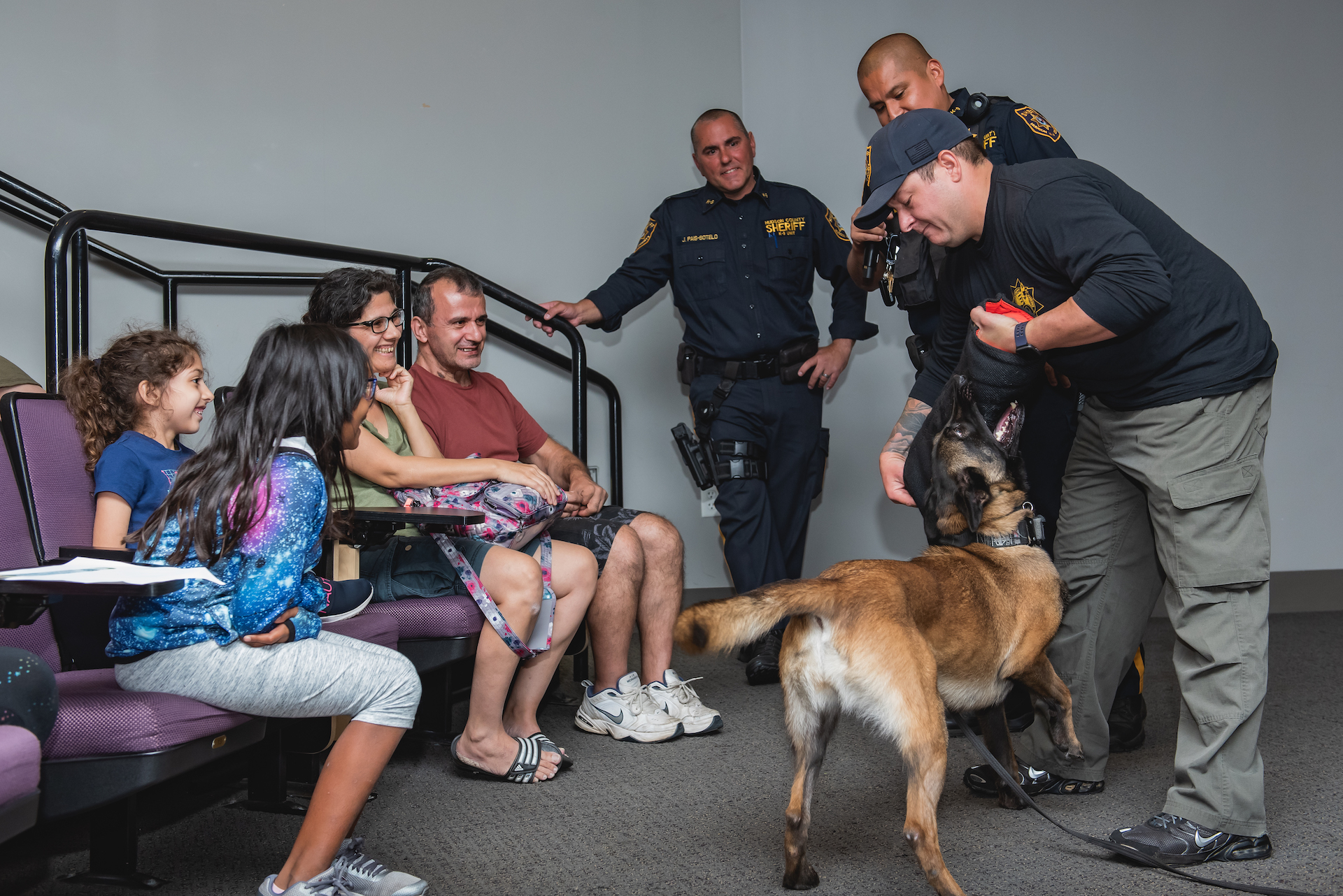 Family meeting dog who is part of Hudson County Sheriff's K9 Unit