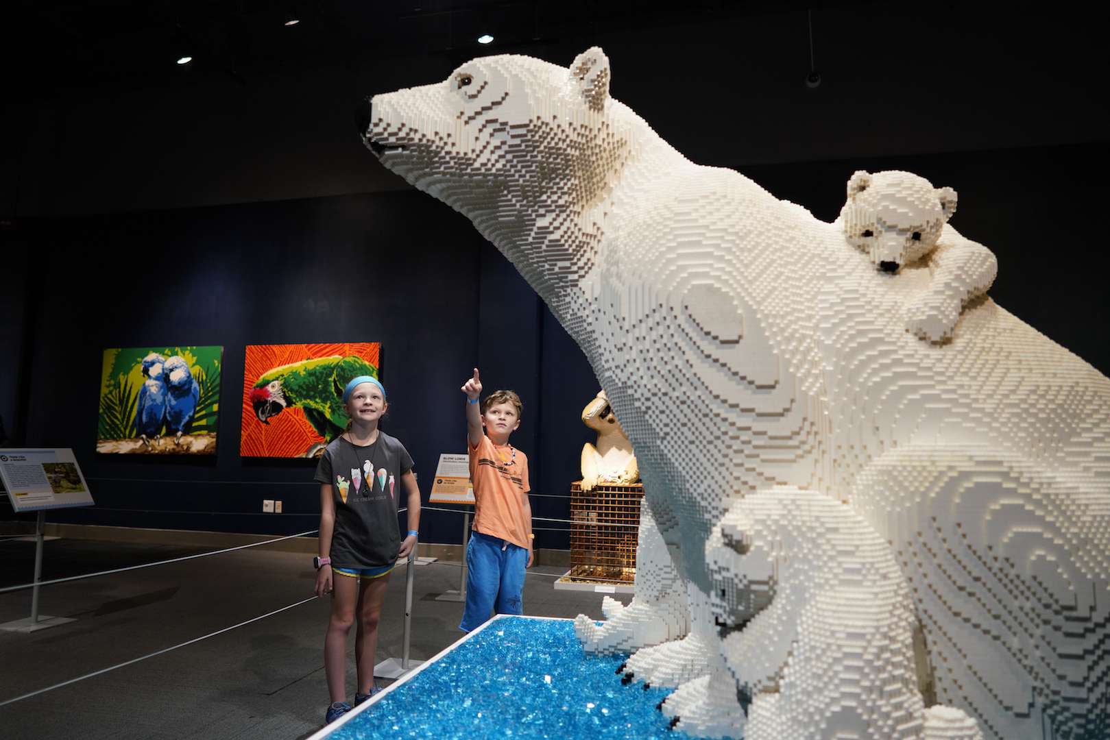 Kids looking at polar bear made out of LEGO pieces