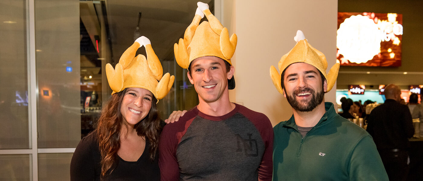 Guests wearing turkey hats at Friendsgiving