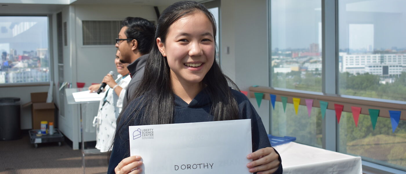 Teen Summer Docent volunteer Dorothy Zhang holds up her certificate