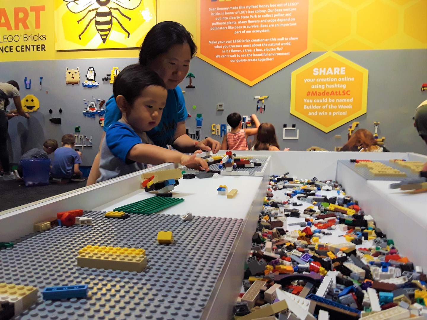 Boy and mother making creations with LEGO pieces