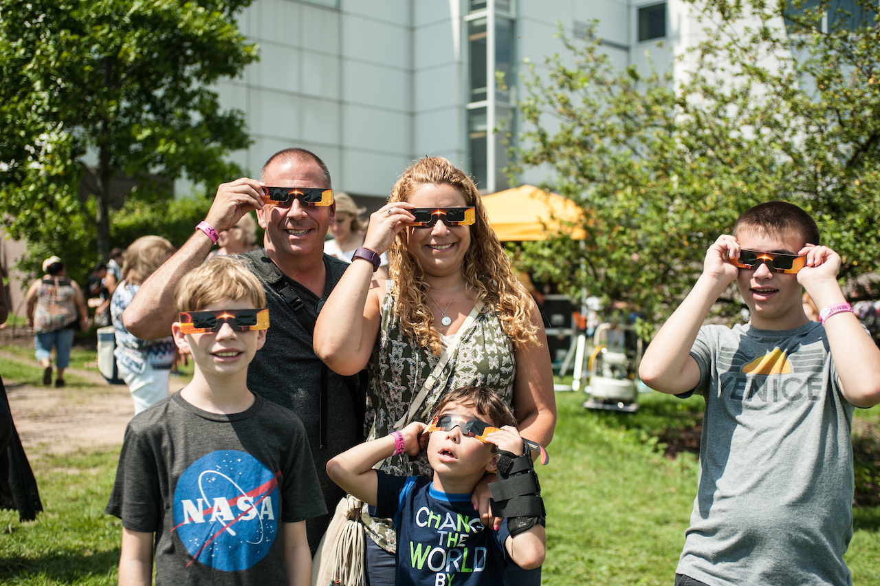 Guests wearing eclipse glasses