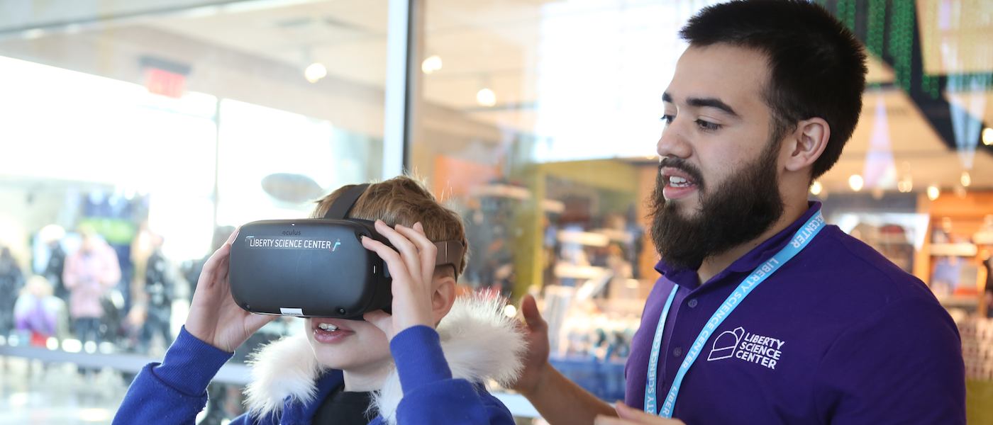LSC staff member and child looking at VR technology