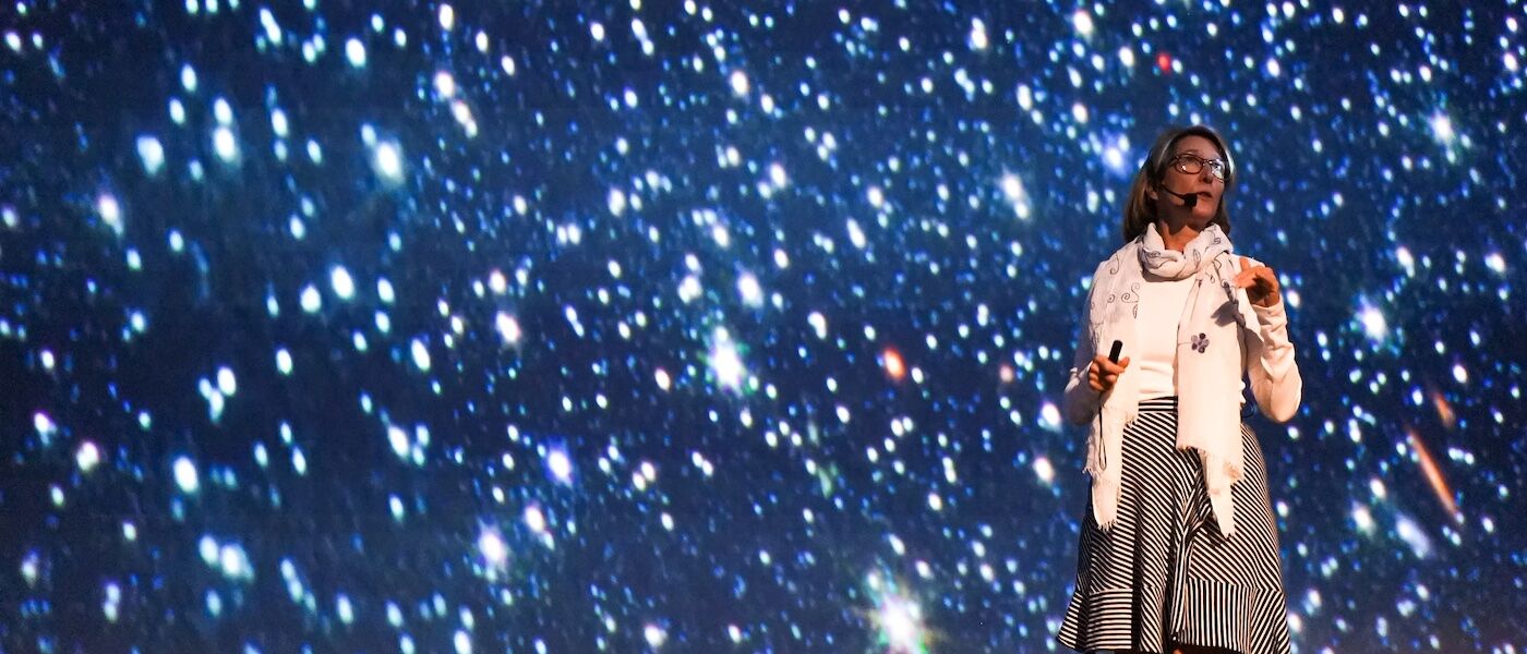 Dr. Kristen McQuinn showing brand new image of Wolf–Lundmark–Melotte in planetarium
