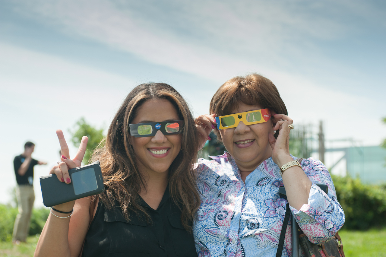 Guests wearing eclipse glasses