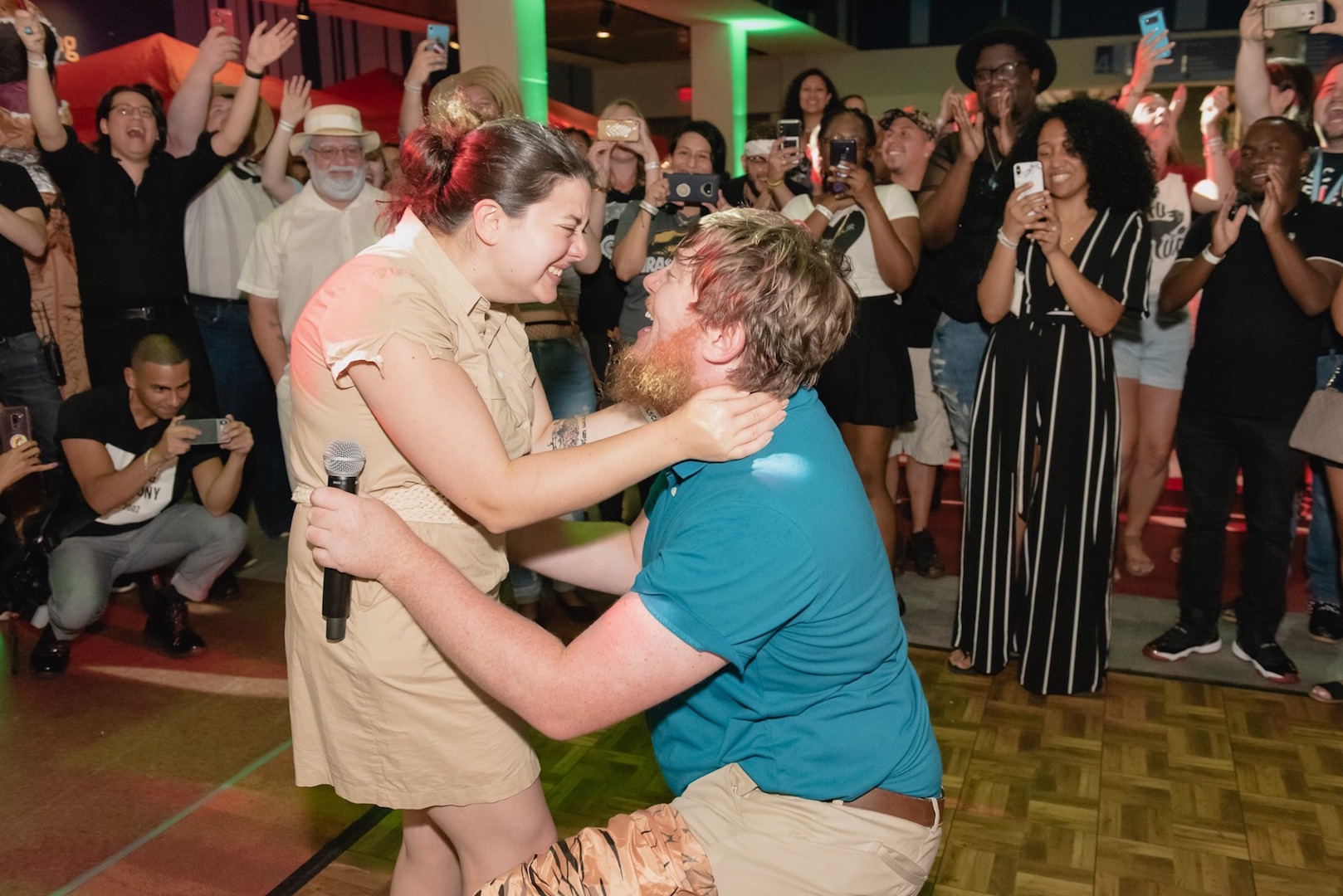 A man proposes to his girlfriend on the dance floor