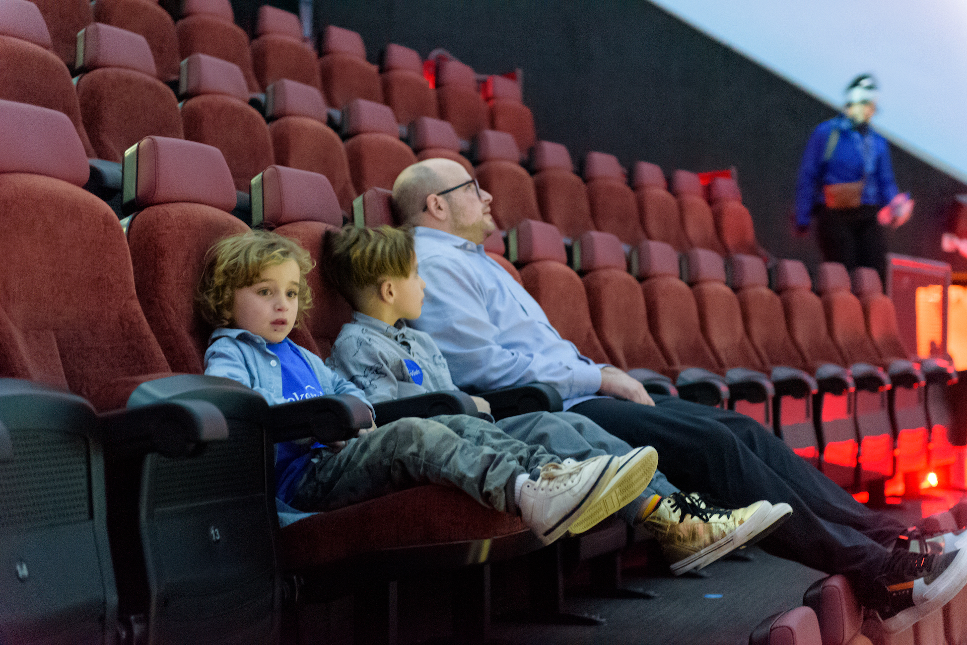 Jules and family get ready to enjoy a dino-themed planetarium show
