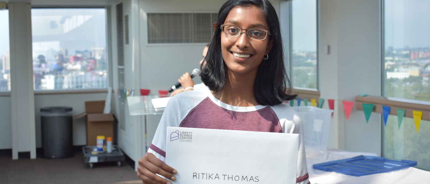 Teen Summer Docent volunteer Ritika Thomas holds up her certificate