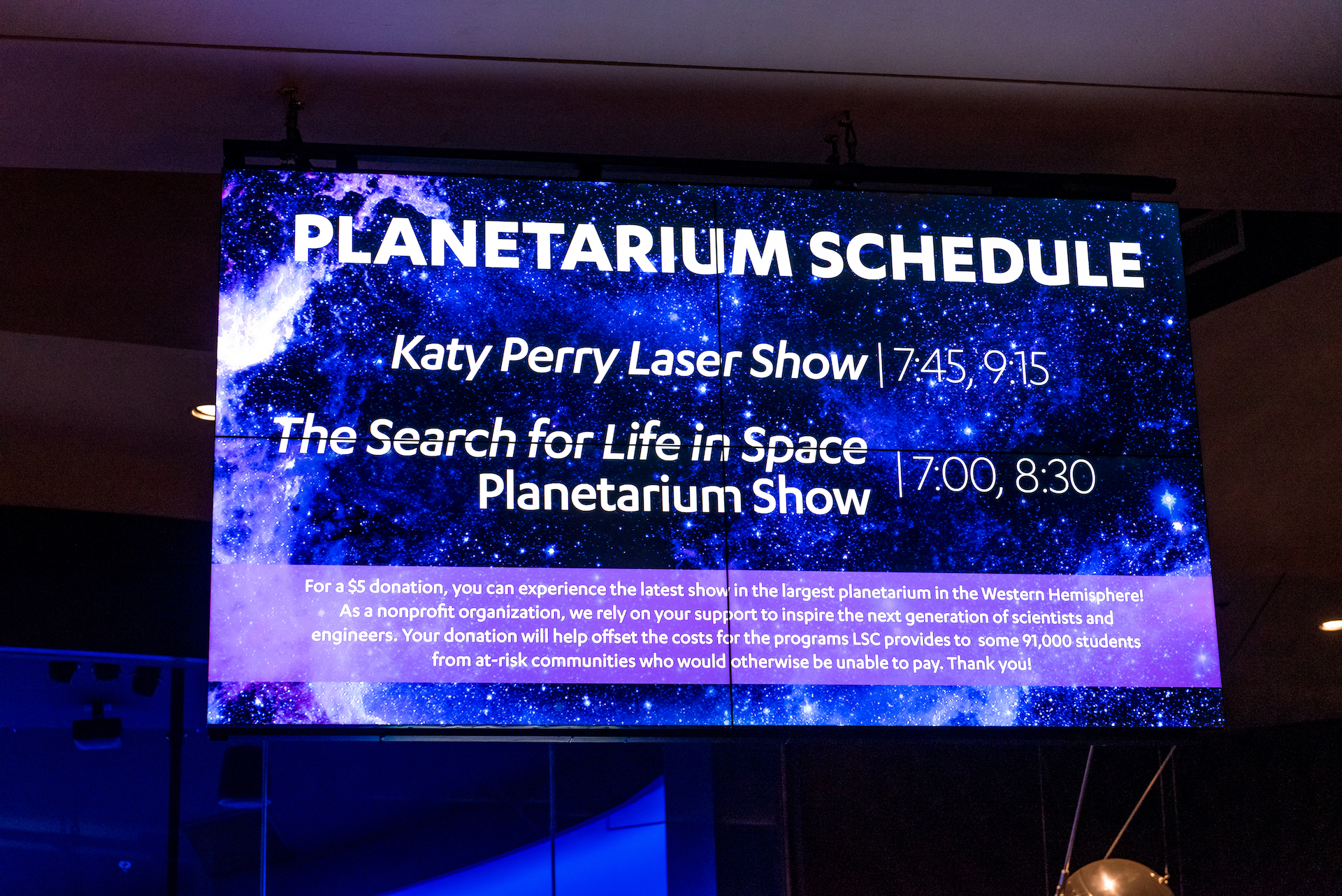Screen showing times for Katy Perry Laser Show and The Search for Life in Space planetarium show