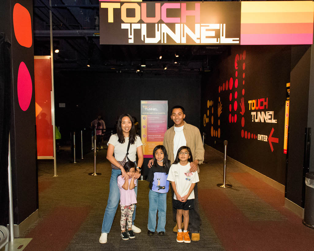 Guests posing in front of the Touch Tunnel