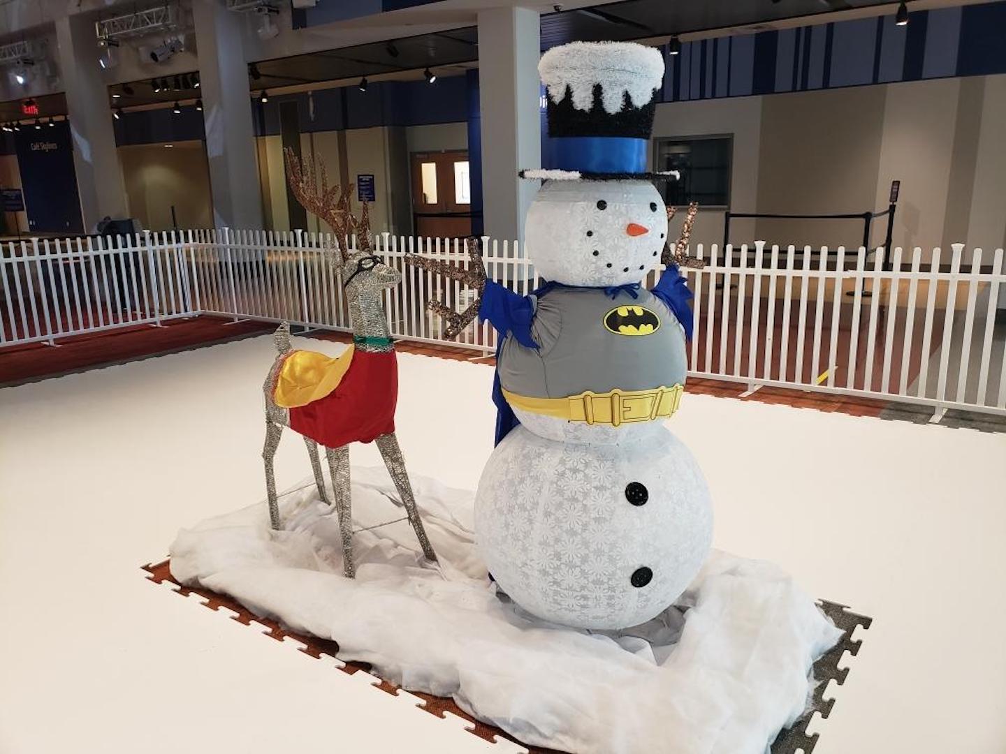 Reindeer and snowman dressed as Batman and Robin in the Sock Skating Rink