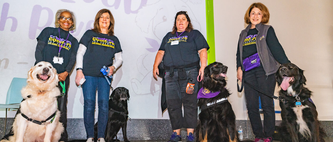 Certified therapy dogs with their handlers